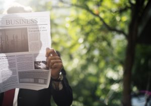 business man reading a newspaper and information about real estate property